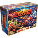 Box art for Crossbows & Catapults: Fortress War board game, showing a vibrant fantasy battle scene with green goblins wielding crossbows against blue armored knights. The colorful illustration features castle siege imagery with medieval fantasy elements, all framed by a treasure chest-styled game box with gold corner accents and the game's logo prominently displayed.