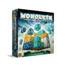 Monolyth board game box featuring a 3D cubic structure made of colorful translucent blocks in blue, green, orange, and gray tones floating against a cloudy sky background. The game title "MONOLYTH" appears in large metallic letters at the top of the box. 