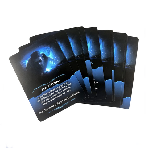 A fan of dark blue and black gaming cards spread out in an overlapping arrangement, featuring dramatic sci-fi artwork of a figure surrounded by blue energy effects. 
