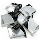 Multiple packages of Ultimate Guard Premium Board Game Sleeves scattered on a white background, showing clear protective card sleeves in their black and white packaging.