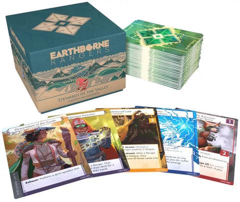 Earthborne Rangers Stewards of the Valley expansion box with a teal and mountain-themed design, displayed alongside stacks of green-backed cards and five sample character cards spread out in front. The box features the Earthborne Rangers logo and "Stewards of the Valley" subtitle with artistic mountain landscapes. 