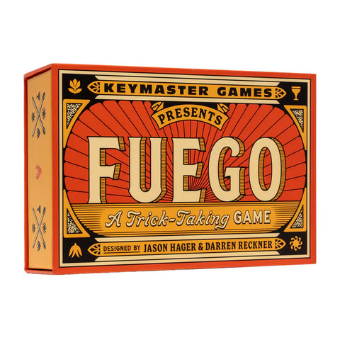 Fuego board game box by Keymaster Games featuring bold orange and red vintage-style design with large decorative lettering. The packaging uses a classic carnival or old-west aesthetic with decorative borders and typography that emphasizes the fire theme of this card game.