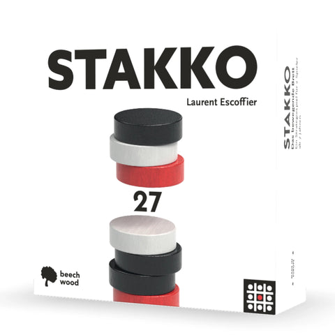 Stakko board game box showing stacked wooden discs in black, white, and red colors arranged in two different tower configurations.