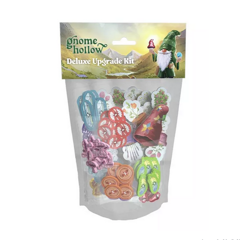 Gnome Hollow Deluxe Upgrade Kit package showing colorful wooden game components through a clear plastic pouch. The kit contains various wooden tokens including blue flowers, red and pink mushrooms, green pea pods, brown acorns, white bones, and other themed pieces displayed against a white background. The package features fantasy artwork with a gnome character and pastoral landscape on the header.