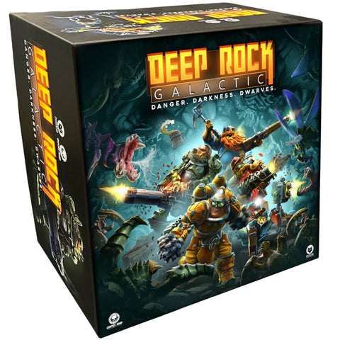Deep Rock Galactic: The Board Game box featuring four armored dwarf miners with futuristic mining equipment and weapons in a dark underground cave setting. The box art shows the dwarves battling large insectoid creatures called Glyphids amid glowing crystals and rocky cavern walls. The game's title appears prominently in bold orange lettering against the dramatic sci-fi mining scene.