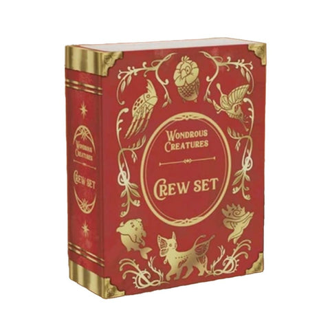 Wondrous Creatures Crew Set expansion box in elegant red and gold Victorian-style design featuring ornate decorative elements. The box displays various mythical creatures rendered in gold foil against the rich burgundy background. Gold corner reinforcements and decorative flourishes give the packaging a premium, antique book appearance.