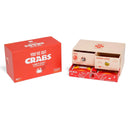 "You've Got Crabs" party game showing the bright red product box alongside an open game box revealing the colorful components inside. The main box features bold white text with a crab icon on a vibrant red background, while the opened box displays card compartments, instruction materials, and game components with ocean-themed artwork.