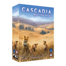 Cascadia: Rolling Hills board game box featuring illustrated foxes in a golden prairie landscape with rolling hills and scattered evergreen trees. The box displays the game title in large white letters against a blue sky backdrop. The artwork showcases the prairie theme with warm earth tones and detailed wildlife illustration by Beth Sobel.