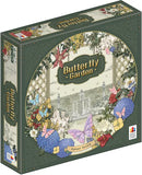Butterfly Garden board game box featuring an ornate circular design with colorful flowers, butterflies, and garden imagery against a vintage green background. The decorative box art shows purple, pink, and yellow blooms surrounding a central garden scene with lattice work and architectural elements. 