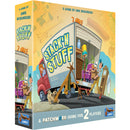 Stack'n Stuff board game box by Uwe Rosenberg featuring colorful artwork of a moving truck being loaded with furniture and household items. The box shows a red moving truck with its cargo door open, revealing people packing various items like furniture, plants, and boxes inside, with a playful cartoon art style. 