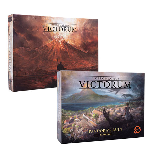 Two board game boxes for Hoplomachus: Victorum are displayed, with the main game box featuring dramatic volcanic landscape artwork and the Pandora's Ruin expansion box showing a coastal town scene. The main game box has a dark, fiery aesthetic with a volcano erupting in the background and a silhouetted figure, while the expansion box depicts a more serene Mediterranean-style settlement with ancient architecture.