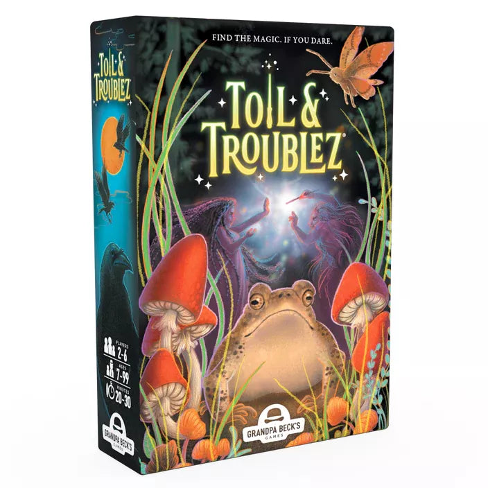 Box art for Toil & Troublez, featuring a large toad surrounded by red mushrooms and magical elements against a dark fantasy background. Two silhouetted witch figures face each other with wands in the center, with the tagline "FIND THE MAGIC. IF YOU DARE." 