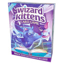 Wizard Kittens card game box featuring a purple and blue magical theme with an illustrated kitten wizard casting spells among floating books and magical elements. The box displays the game title in large white letters against a mystical library background with swirling magical effects. This Library Edition includes the Magical Monsters expansion as indicated by text at the bottom of the colorful packaging.